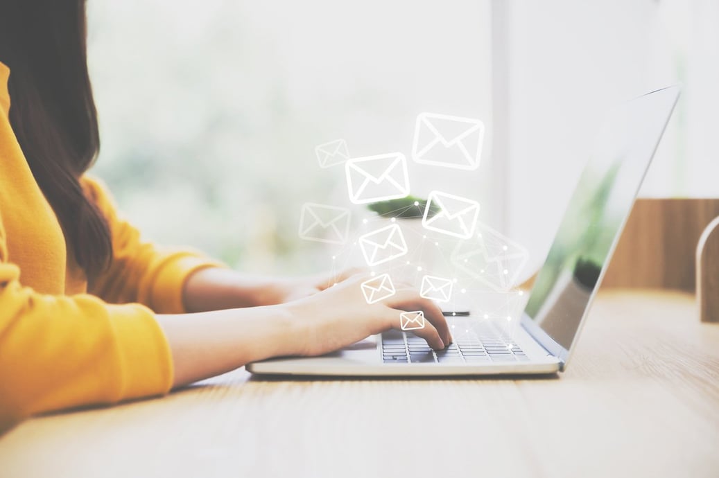 Small business owner choosing the best email marketing service on a laptop | Shift4Shop