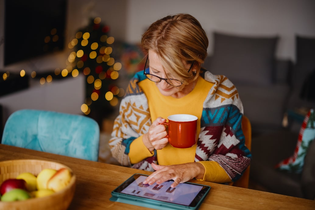 Woman shopping for the 2023 holiday season online with a tablet - Shift4Shop