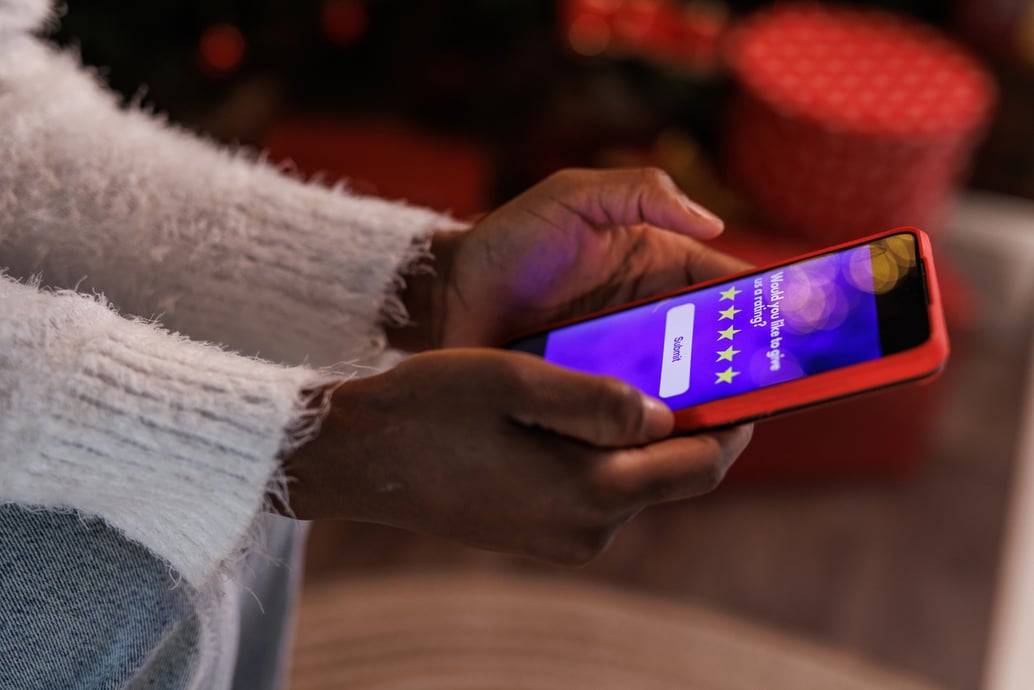 Customer filling out a post-purchase survey on her phone | Shift4Shop