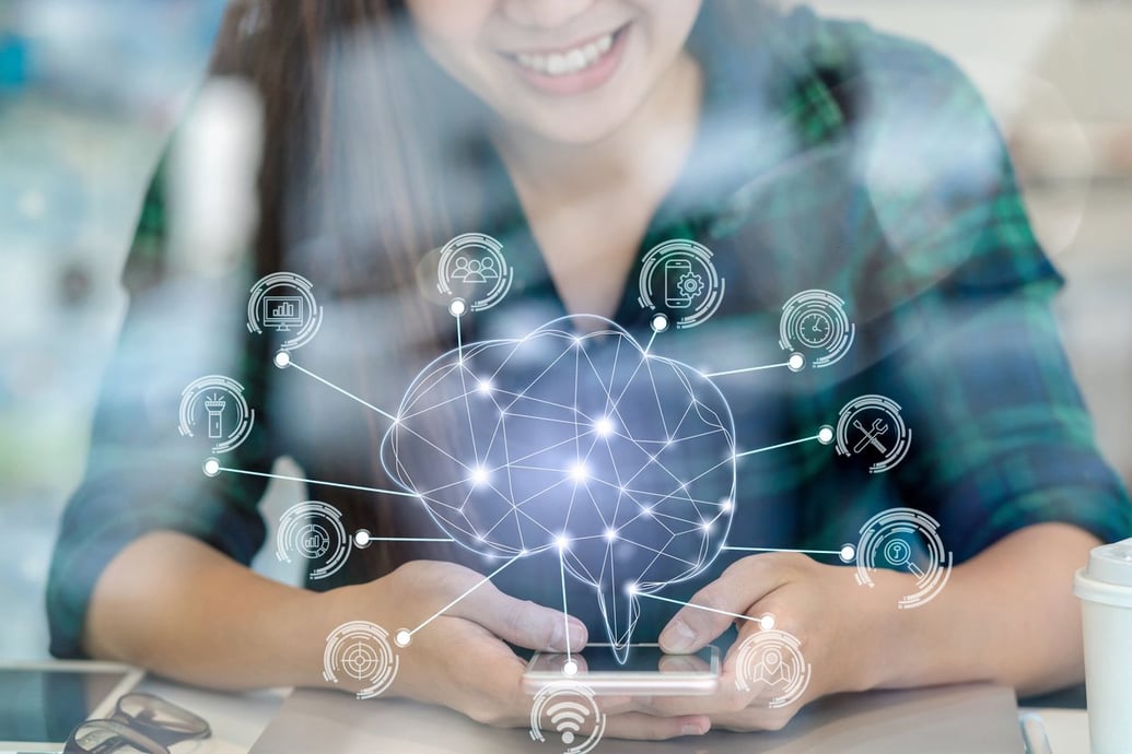 Woman shopping online with a graphic brain representing AI personalizing her eCommerce experience - Shift4Shop