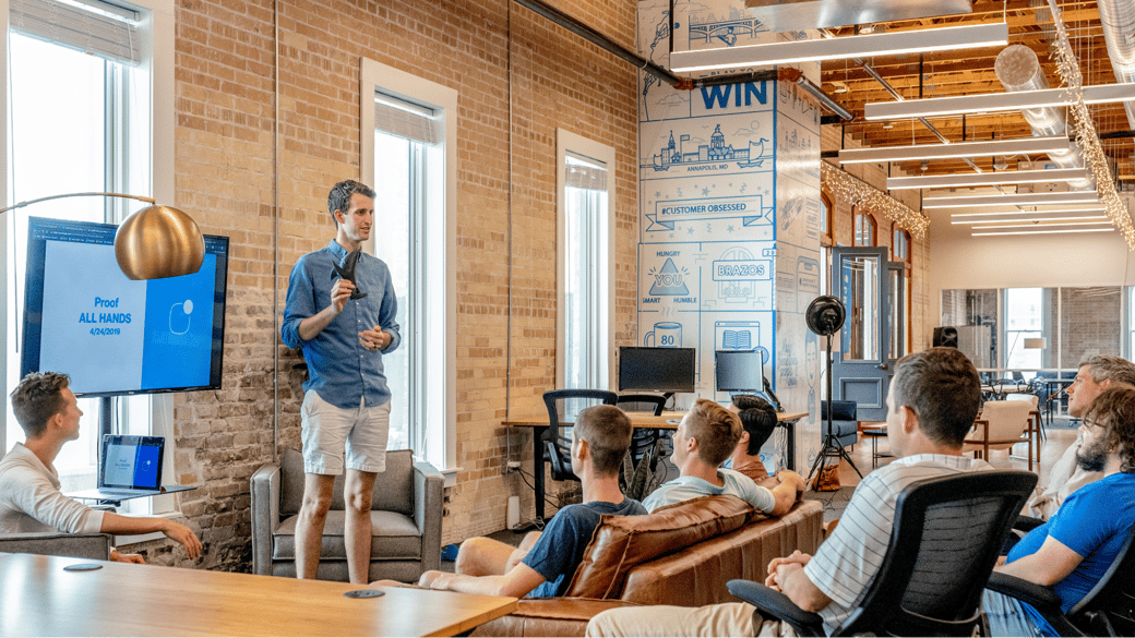 Employees in a room setting transformative business goals